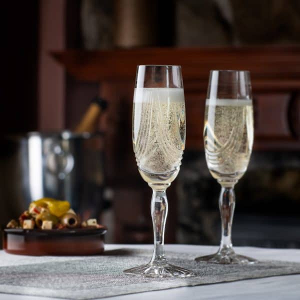 Montrose Champagne flute set of 2 produced by Glencairn crystal, picture shows they are on a table containing champagne